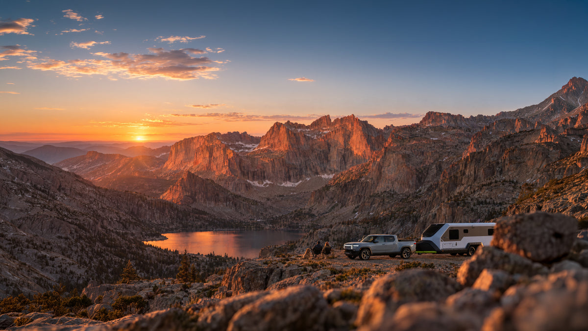 Evotrex PG5 and a pickup overlooking a mountain lake at sunset.